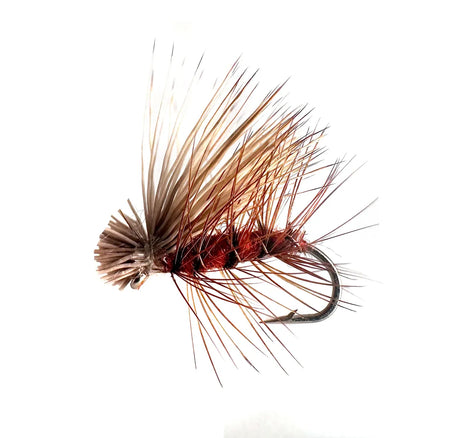 A close-up photograph showing the Elk Hair Caddis Dry Fly in sizes #12, #14, #16, and #18. The flies feature a natural brown body and a durable, high-floating bleached elk hair wing, ideal for caddis hatches and fast water.