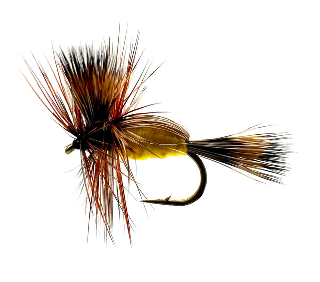 A close-up photograph showing the Yellow Humpy Dry Fly in sizes #12 and #14. The flies feature a bright yellow body, durable deer hair construction, and a realistic "hump" shape, ideal for high-floating presentations in fast water.